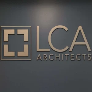 3D letter signage at an architect office on a dark grey wall