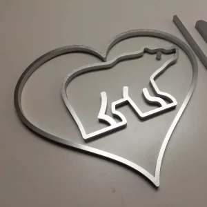 a metal 3d line in the shape of a heart, with another shape of a bear inside of it
