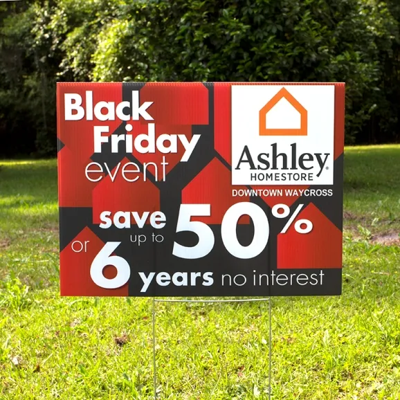 A yard sign advertising a sale for a furniture store.